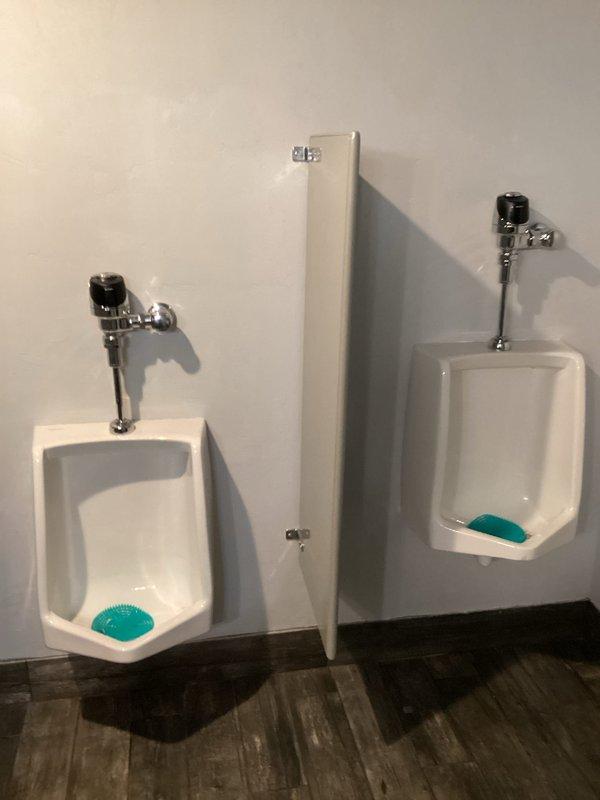 Responded to a reported low water pressure issue at restaurant. Diagnosed problem as leaking urinal affecting building pressure. Isolated urinal water supply while restoring main water service to kitchen. Tested urinal functionality after restoration, confirming both push button and motion sensor operation functioned properly. Restored normal water pressure to establishment.