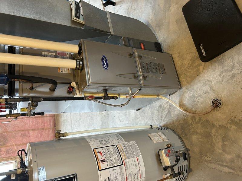 Performed diagnostic tune-up on Carrier furnace for new homeowner reporting intermittent operation issues and unusual noises. Conducted thorough inspection including test run, gas pressure adjustment, air filter check, and heat exchanger examination. Identified oil leak from blower motor requiring warranty verification, though all systems currently operating within normal parameters.