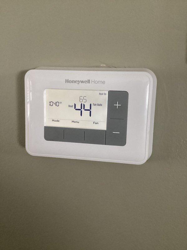 Diagnosed non-operational furnace due to dead thermostat batteries. Replaced batteries and verified system operation. Furnace restarted successfully with thermostat now displaying proper temperature (44°). Advised customer about potential condensate trap freezing in high-efficiency unit and recommended maintaining home temperature above 55°.