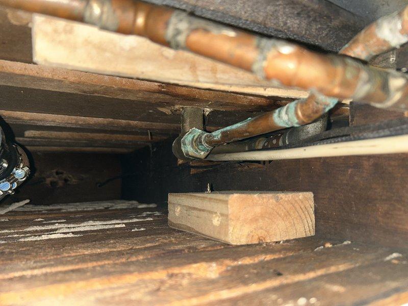 Located and repaired a vertical pipe leak in basement that was occurring when bathroom water was running. Replaced deteriorated copper pipe showing significant oxidation and green patina at joints. Also replaced faulty shower cartridge which was contributing to the leaking issue.