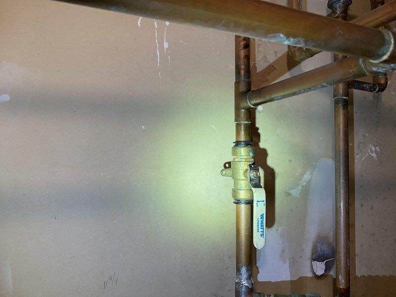 Inspected non-functional Culligan water softener system showing significant deterioration, including visible oxidation on copper pipes and water damage on surrounding wall. System exhibited structural damage that compromises functionality. Provided comprehensive replacement options to client after evaluation of current unit's condition.