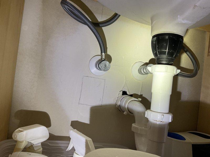 Responded to a water leak service call for master bathroom sink. Identified leaking plastic angle stops and supply tube on left side of vanity with visible water damage to cabinet base. Replaced faulty stops and supply tubes in master bathroom, main bathroom, and powder bathroom to prevent further damage.