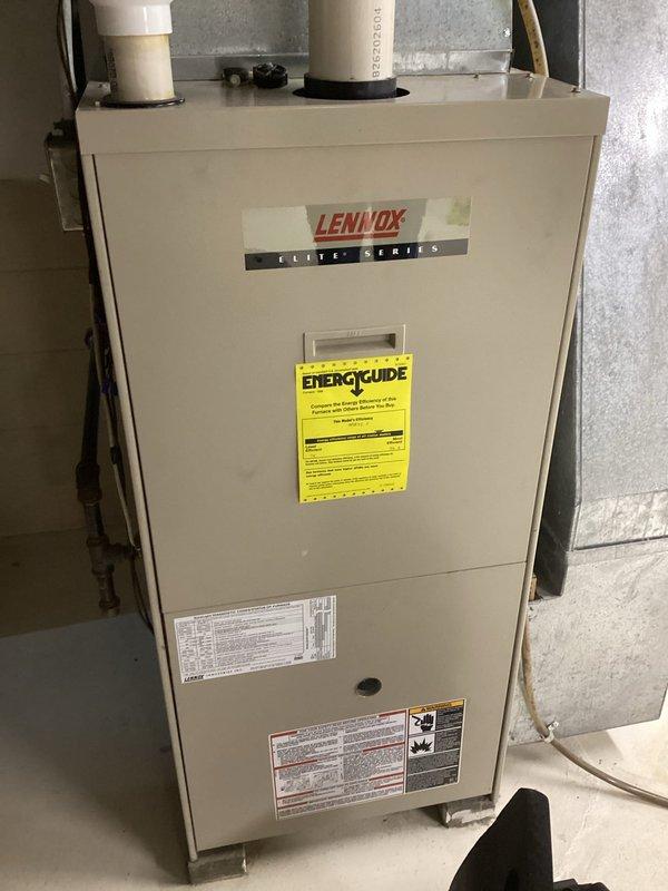 Performed routine tune-up on 23-year-old Lennox Elite Series furnace. Visual inspection revealed heat exchanger cracks around I-bolts, a typical failure point for this model. Unit was tagged out of service for safety concerns, and customer was advised of repair options versus replacement. Checking availability of heat exchanger parts while customer considers recommendations.