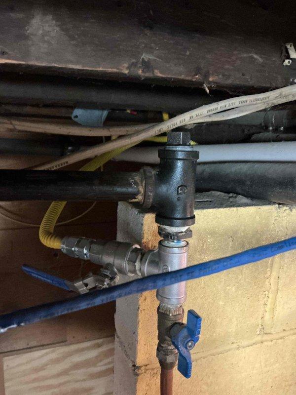 Responded to a gas leak identified by Center Point Energy affecting the main pipe above water heater. Confirmed leakage at two fittings using soap bubble test, tightened cap on one leaking fitting with pipe dope application, and removed an unused gas line as requested by customer. Successfully tested repaired connections for leaks and restored water heater to service by relighting pilot.