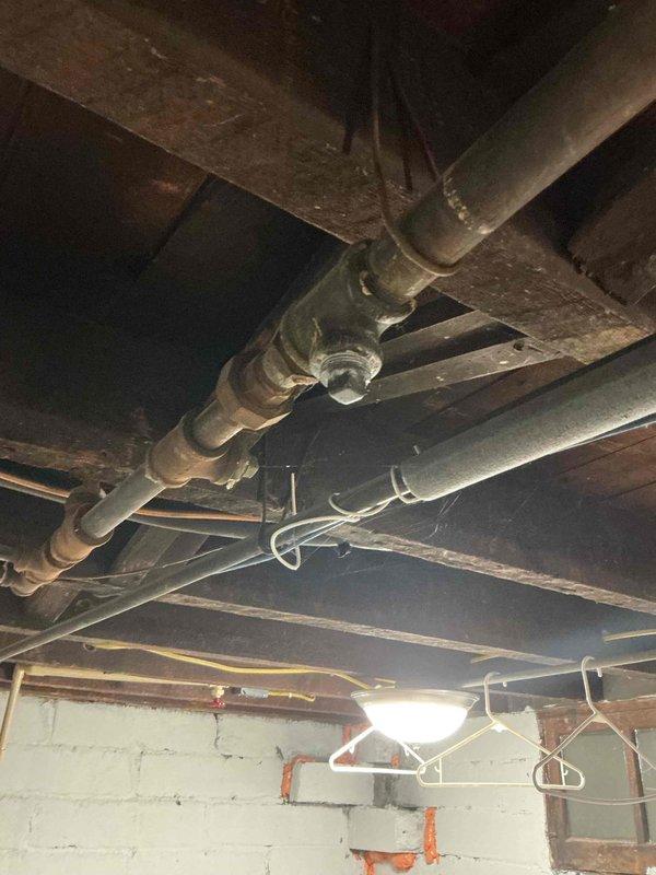 Responded to a gas leak identified by Center Point Energy affecting the main pipe above water heater. Confirmed leakage at two fittings using soap bubble test, tightened cap on one leaking fitting with pipe dope application, and removed an unused gas line as requested by customer. Successfully tested repaired connections for leaks and restored water heater to service by relighting pilot.