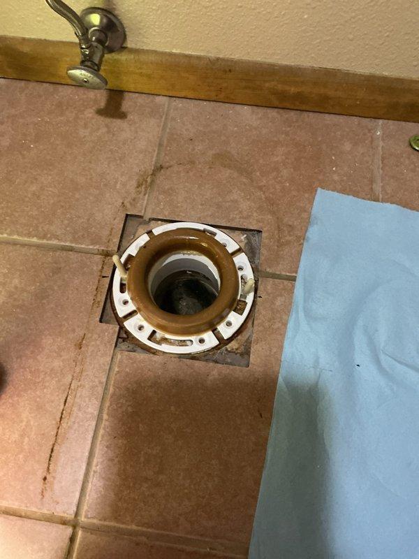 Responded to service call for toilet leaking at the base when flushed. Diagnosed failed wax seal and broken closet flange that was positioned below floor level. Replaced the damaged flange, elevated it to proper installation height, and installed new wax seal to resolve the leak.
