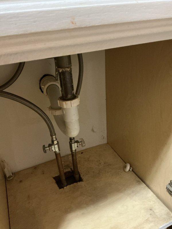 Inspected bathroom sink with reported cold water leak. Found dripping supply line connection at shut-off valve. Advised customer regarding options to replace stop valve and supply line immediately or replace entire vanity due to water damage and cabinet deterioration. Customer elected to procure new vanity and faucet themselves, with installation to be scheduled at a later date.