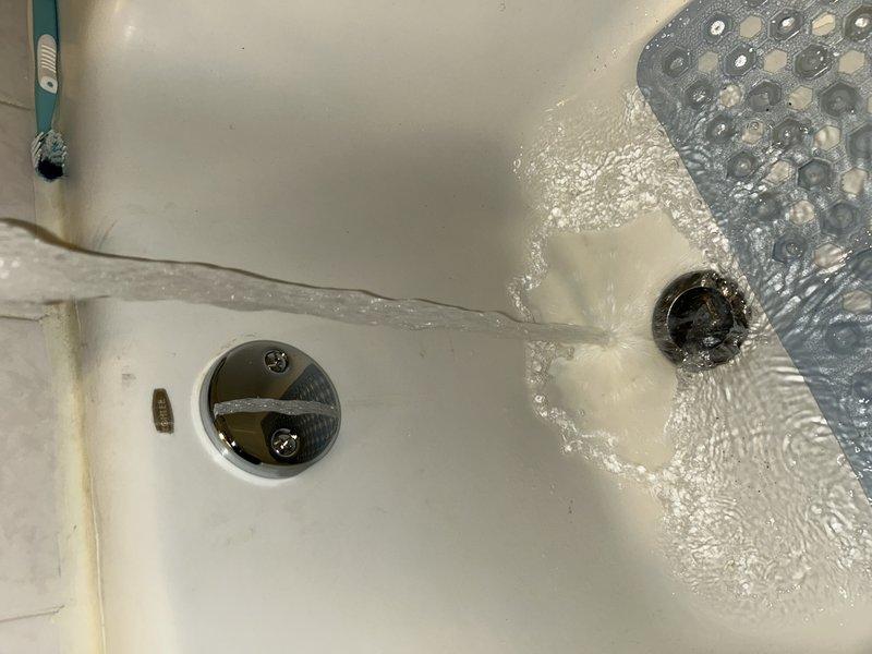 Responded to a water leak complaint originating from upstairs bathroom shower and extending to basement. Diagnostic inspection revealed water intrusion through ceiling when bathtub/shower was in use. Located defective tub waste and overflow assembly. Successfully replaced tub waste and overflow components, effectively resolving the leak issue.