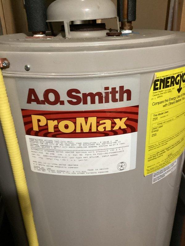 Conducted comprehensive maintenance service on a 19-year-old furnace that has reached the end of its expected service life (15-20 years). Performed complete safety, efficiency, and reliability inspection, including electrical measurements with clamp meter (detected 0.009 amp reading). Noted several concerns with the aging unit, which were documented with supporting photographs of the system components and adjacent A.O. Smith ProMax water heater installation.