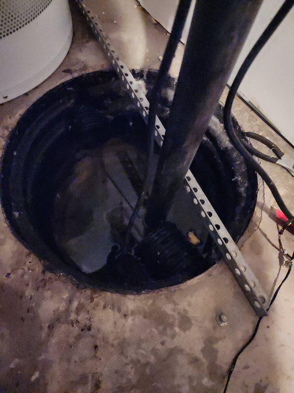 Responded to customer service call for disconnected sump pump discharge pipe. Discovered check valve was detached due to insufficient pipe length, causing the system to malfunction and begin filling to flooding point. Replaced elbow fitting and extended discharge pipe to proper length, ensuring secure connection to check valve and restoring proper sump pump operation.