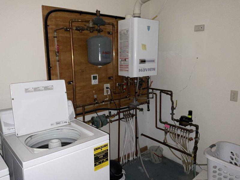 Responded to a customer complaint of intermittent hot water loss during showers with their Navien tankless water heater. Upon inspection, found that the existing unit showed signs of age-related deterioration and active leaking. Conducted a thorough evaluation of the system and provided customer with replacement options for both the tankless water heater and the addition of a water softener to prevent future scaling issues and extend equipment lifespan.