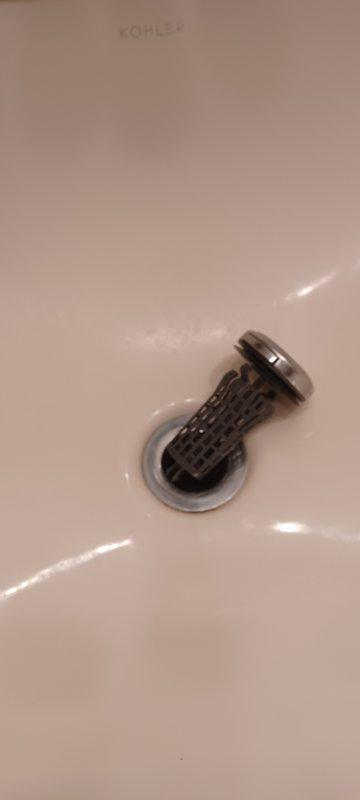 Replaced leaking hot water cartridge in kitchen faucet and installed new pop-up drain assembly in bathroom sink. Both customer-supplied parts were successfully installed, resolving the dripping issue from the hot side of the kitchen faucet.