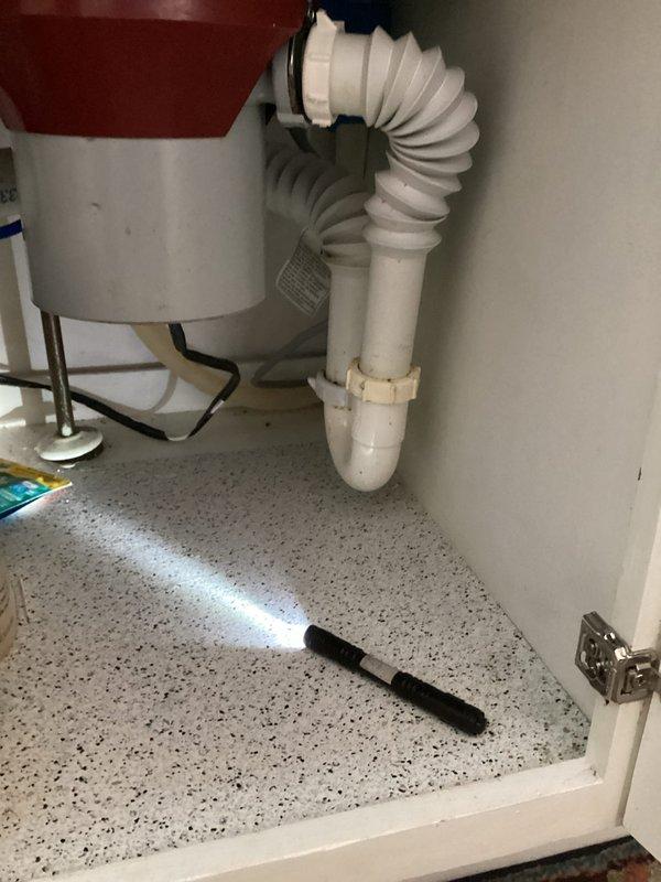 Responded to a kitchen sink clogged drain issue with evidence of leaking from the garbage disposal when plunged. Diagnostic revealed poor piping configuration from disposal to drain. Completed full repiping of under-sink plumbing and ran snake through the entire system down to the 3-inch cleanout to restore proper drainage. Noted to customer that garbage disposal is approaching end of service life.