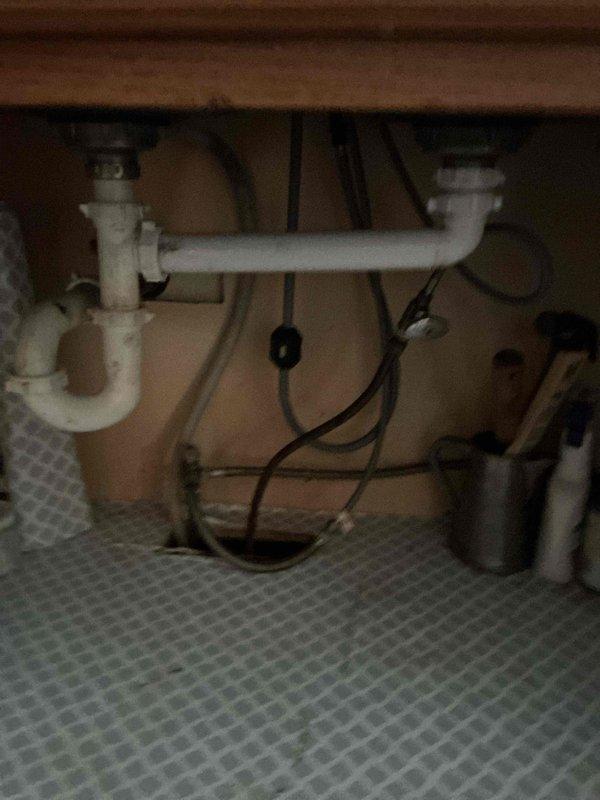 Responded to service call for a clogged kitchen sink. Upon inspection of the double-basin black sink, water drainage issues were evident. Successfully cleared the blockage using drain snake technique on the kitchen sink drain line. Confirmed proper drainage functionality after service completion.