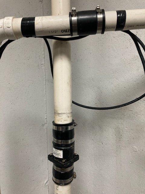 Inspected homeowner's sump pump system that had been previously repaired with hose clamps and electrical tape. Identified leaking check valve in sewer ejector system. Reviewed proper installation requirements with customer who elected to perform the replacement themselves.