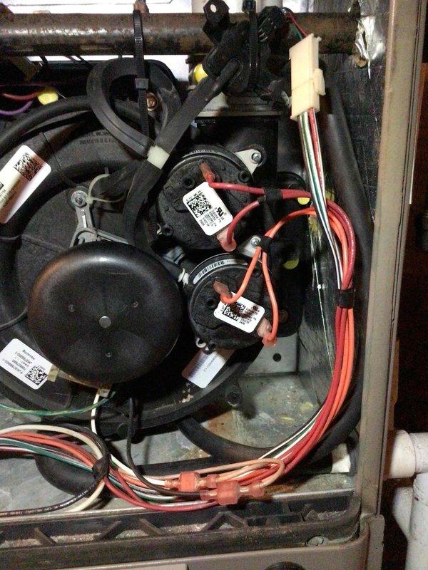 Diagnosed and replaced dual pressure switches in heating unit that was not operating. After installation, identified issue with "stuck closed" switch error code. Verified tubing and connections were clear, then cleaned pressure switch sensor plug on control board. Unit now operates normally through multiple test cycles with proper sequencing and no error codes.