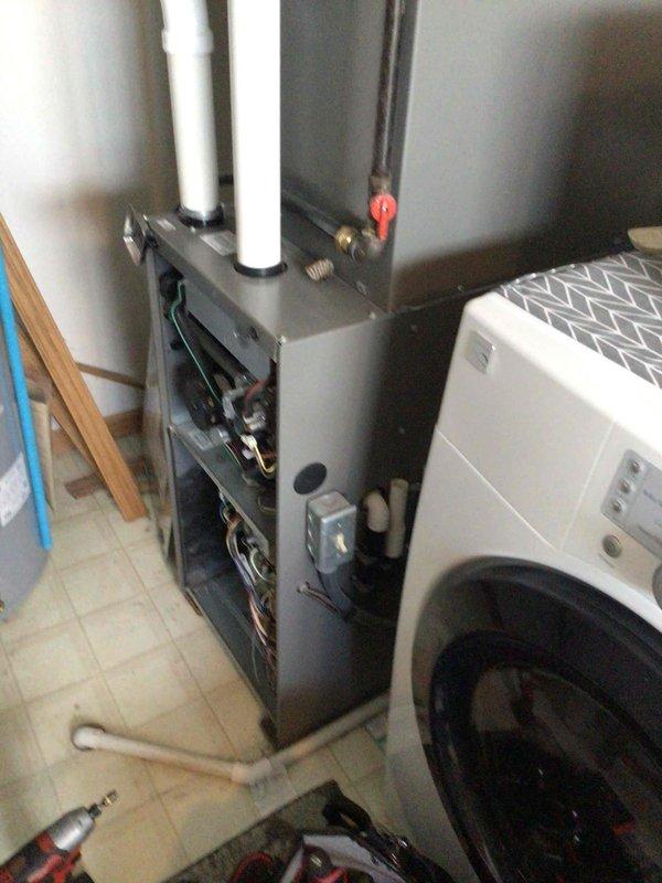 Performed standard furnace maintenance tune-up on residential unit. System functioning within normal parameters after cleaning flame sensor, testing electrical components, and removing wasp nest from intake. No operational issues detected.