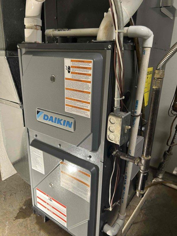 Diagnosed recurring water leak in Daikin furnace, identified loose screws on inducer assembly causing internal leakage. Removed components, cleaned affected compartment, tightened hardware, and reassembled unit. System tested operational with no further water leakage detected.