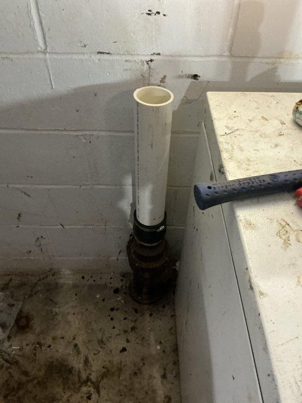 Repaired broken drain pipe in basement that connected to kitchen sink. Identified failed coupler which broke during customer's attempt to clear a clog. Removed damaged section and re-piped portion of the drainage system, replacing the corroded metal fitting with new PVC components to restore proper waste water flow.