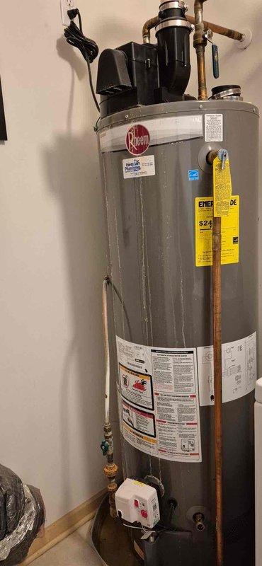 Diagnosed Rheem 40-gallon POWER VENT water heater with active leak. Inspection revealed compromised internal glass lining, resulting in water corrosion through the aluminum shell. Unit deemed unrepairable; provided replacement options to customer.