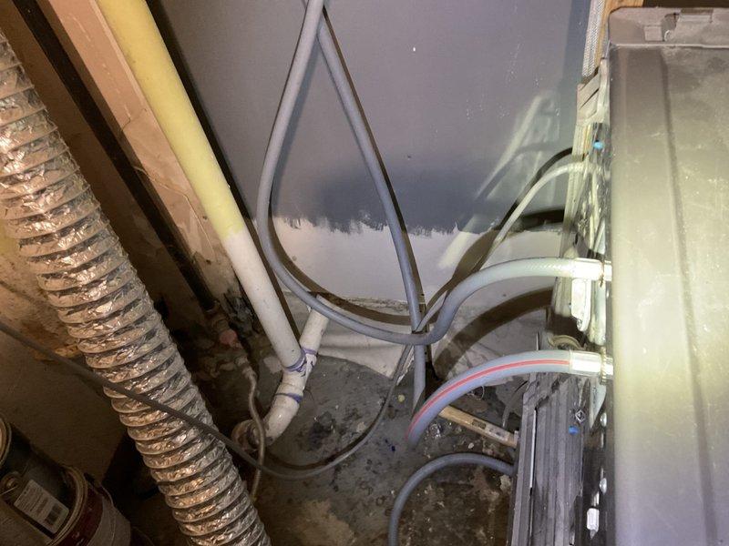 Responded to a service call for a clogged washer sink drain. Upon inspection, discovered the washing machine discharge hose had been displaced from the floor drain, causing water to overflow onto the floor. Tested floor drain functionality with hose, confirmed proper drainage, and correctly repositioned the washer discharge hose. Recommended installation of a 2" P-trap and standpipe for washing machine discharge to prevent future issues.