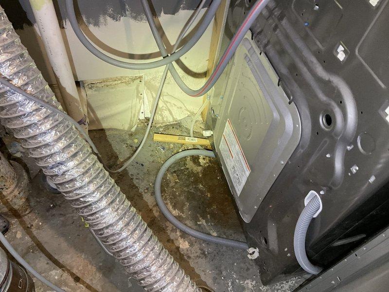 Responded to a service call for a clogged washer sink drain. Upon inspection, discovered the washing machine discharge hose had been displaced from the floor drain, causing water to overflow onto the floor. Tested floor drain functionality with hose, confirmed proper drainage, and correctly repositioned the washer discharge hose. Recommended installation of a 2" P-trap and standpipe for washing machine discharge to prevent future issues.