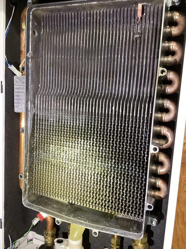Responded to no heat/no hot water service call for a 2020 boiler. Diagnosed plugged condensate trap causing water backup. Performed comprehensive tuneup including thorough cleaning of heavily soiled heat exchanger with significant dust accumulation on fins, restored proper system operation, and enrolled customer in rewards program.