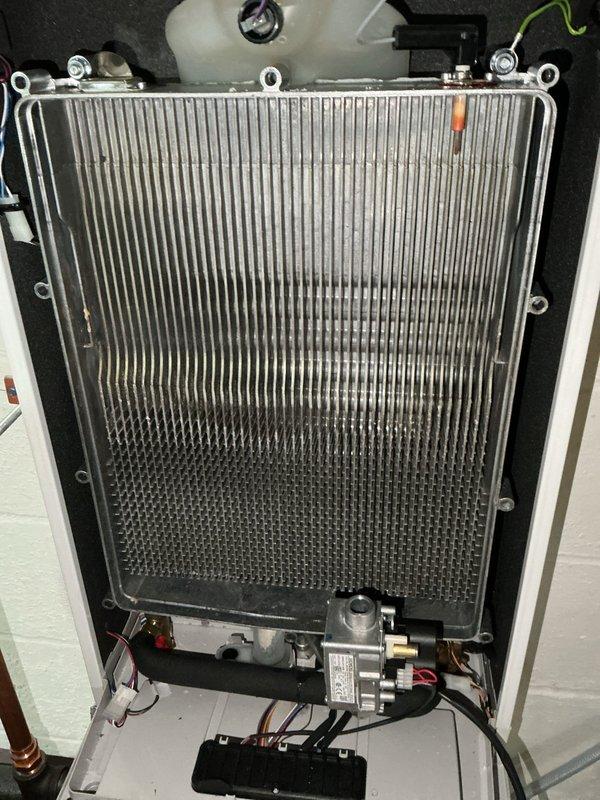 Performed complimentary heat exchanger cleaning on tankless water heater as scheduled. Flushed the water side of the unit, removing a small amount of sediment from the heat exchanger. Disassembled the heat exchanger to clean internal channels. System is now functioning properly with no issues detected. Discussed potential water quality equipment upgrades with homeowners, who will monitor water quality for approximately one year due to recent road construction that may have contributed to sediment.