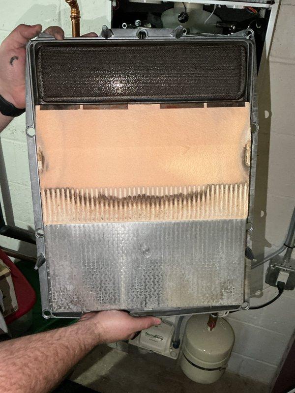 Performed complimentary heat exchanger cleaning on tankless water heater as scheduled. Flushed the water side of the unit, removing a small amount of sediment from the heat exchanger. Disassembled the heat exchanger to clean internal channels. System is now functioning properly with no issues detected. Discussed potential water quality equipment upgrades with homeowners, who will monitor water quality for approximately one year due to recent road construction that may have contributed to sediment.