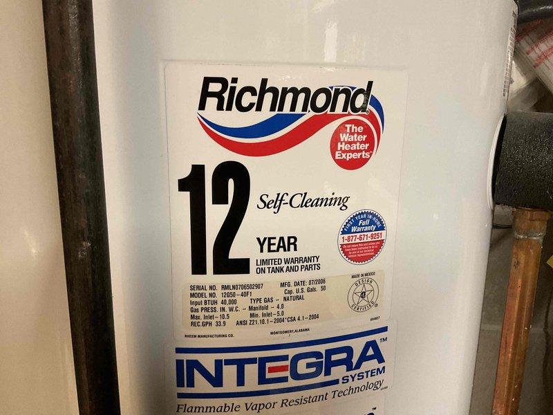 Responded to customer complaint of onion-like odor from hot water supply. Examined 17-year-old Richmond water heater (model 12S50-40F1, manufactured 07/2006) which was functioning properly despite age. Attempted to remove anode rod to address sulfur smell issue but found it seized. Advised customer against further removal attempts due to risk of tank damage on aged unit and recommended complete water heater replacement as most appropriate solution.