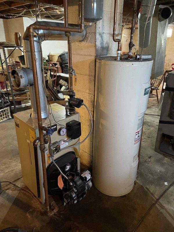 Performed annual PM service on oil boiler system. Changed oil filter but deferred nozzle replacement due to non-standard size requirement on Weil McClain unit. System inspection showed proper boiler temperature/pressure readings and normal pump operation. Addressed customer concerns about discolored domestic water, explaining this was unrelated to boiler system and likely due to stagnant water in pipes. Will return to complete nozzle replacement with correct size.