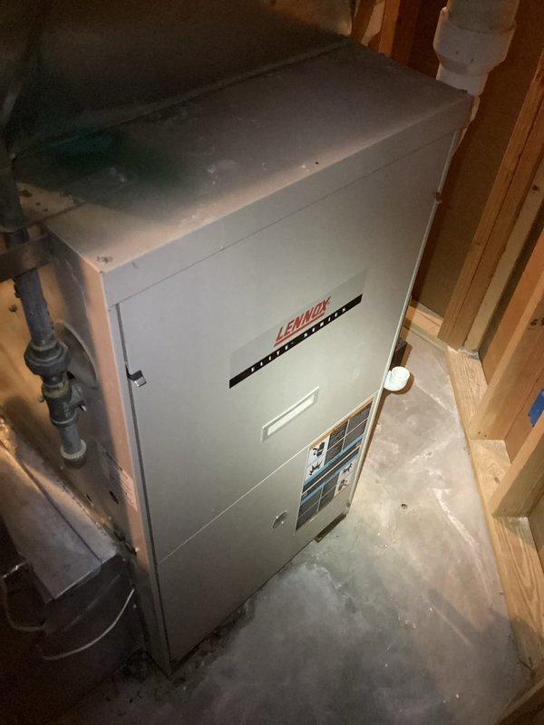 Responded to service call for Lennox Elite Series furnace with intermittent ignition failures requiring daily resets. Diagnosed and cleaned corroded flame sensor, inspected heat exchanger, and verified all electrical components were within specifications. Furnace subsequently operated properly with normal heating function. Identified minor water leak from collector box and presented repair options to homeowner. Customer declined immediate collector box repair but may consider complete system replacement in summer due to unit's 20-year age.