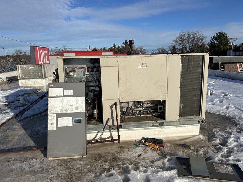 Responded to no heat complaint at commercial property for 10+ year old RTU serving the foyer area. Diagnosed locked combustion blower motor as the cause of heating failure. Performed temporary repair by manually freeing the blower and lubricating components. Conducted heat exchanger inspection with no cracks or holes observed. Customer approved estimate for replacement of combustion blower assembly.