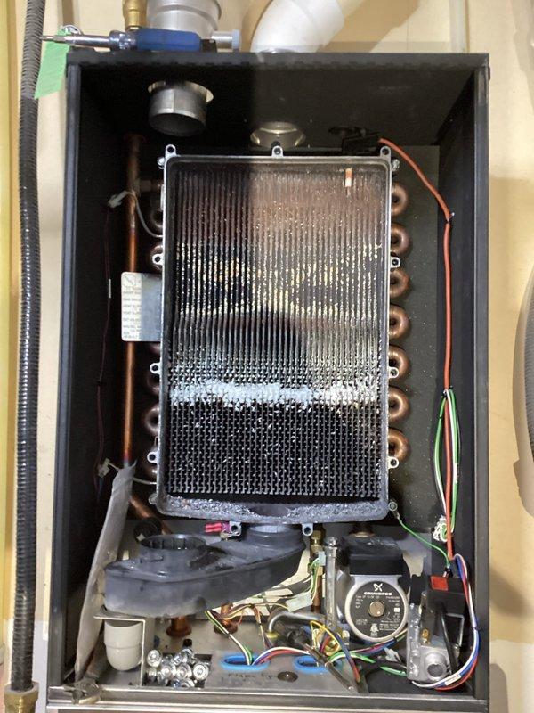 Performed scheduled maintenance on IBC combi boiler as part of recurring service agreement. Found heavily plugged heat exchanger which required extensive cleaning; also flushed condensate, cleaned flame sensor, and restored system pressure to proper level from 8 psi. All operations verified normal after service completion.