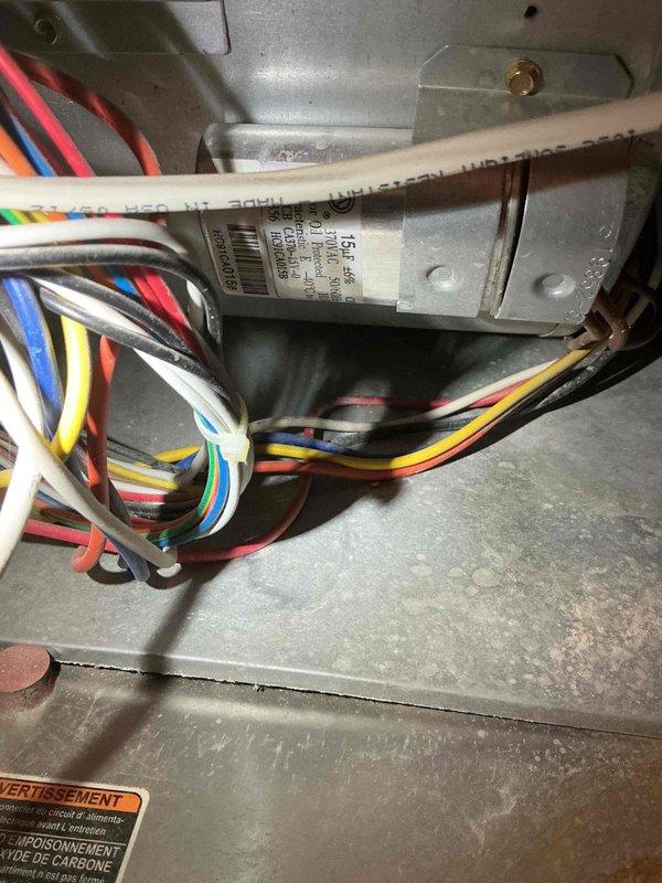 Performed comprehensive tune-up inspection on 14-year-old Carrier furnace. Verified good condition of blower motor, draft motor, capacitors, control board, and gas valve with normal combustion readings. Discovered and documented critical safety issue: hole in primary heat exchanger near the high limit. Due to potential carbon monoxide hazard, performed mandatory safety shutdown of equipment and explained necessity to homeowner.