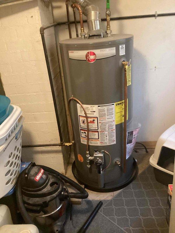 Responded to service call for toilet drainage issues and overflow problems. Diagnosed toilet as clogged with calcium buildup causing poor drainage. Inspected laundry tub and provided replacement estimate as requested by tenant.