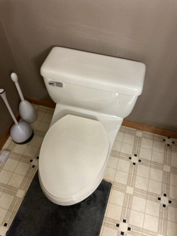 Responded to service call for toilet leaking from tank supply line. Diagnosed cross-threaded supply line to fill valve on basement toilet. Replaced supply lines for all four toilets in the residence to prevent similar issues, as all fixtures were of similar age and condition.