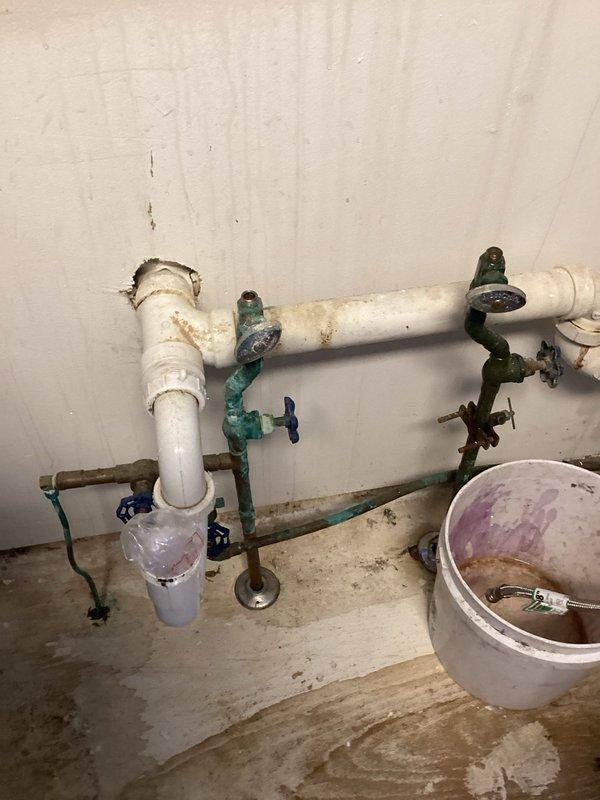 Successfully disconnected and capped copper waterlines under kitchen sink to facilitate customer's remodel. Noted significant corrosion in basement copper lines that may require future attention. Documented existing water treatment system consisting of dual filtration tanks and WELL-TRO pressure tank for reference.
