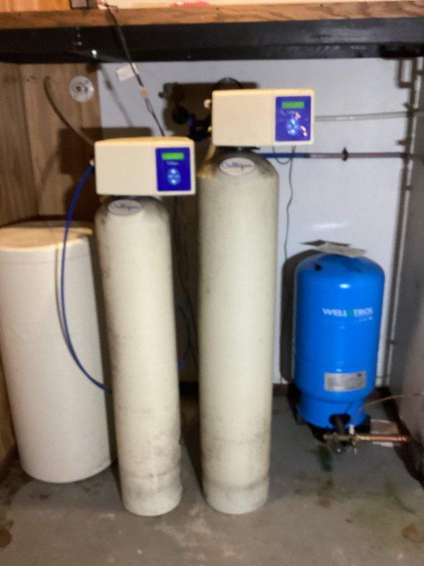 Successfully disconnected and capped copper waterlines under kitchen sink to facilitate customer's remodel. Noted significant corrosion in basement copper lines that may require future attention. Documented existing water treatment system consisting of dual filtration tanks and WELL-TRO pressure tank for reference.