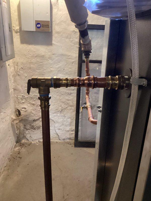 Responded to customer-reported leak on previously installed boiler. Diagnosed and repaired leaking packing nut on pump flange by tightening the loose fitting. Additionally, corrected a code violation by reinstalling the pressure relief valve vertically instead of horizontally. System operation verified through thermostat cycling test.