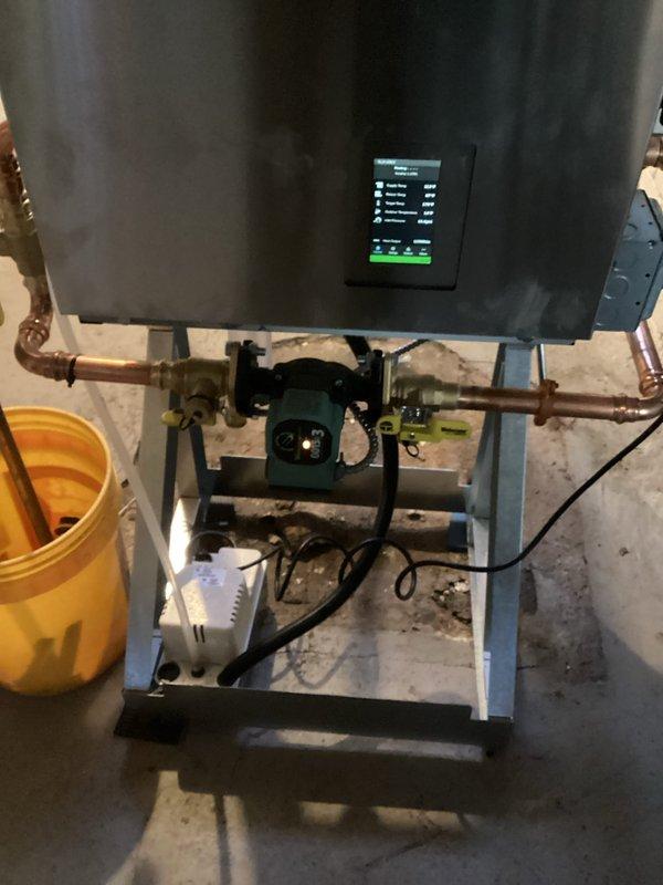 Responded to customer-reported leak on previously installed boiler. Diagnosed and repaired leaking packing nut on pump flange by tightening the loose fitting. Additionally, corrected a code violation by reinstalling the pressure relief valve vertically instead of horizontally. System operation verified through thermostat cycling test.