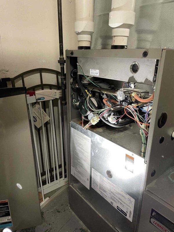 Performed routine maintenance on the main house Lennox natural gas furnace. Inspection revealed rusting under the inducer from a previously repaired leak, and a filter beginning to show signs of contamination. All other components and operations checked satisfactory, and the unit is functioning properly.