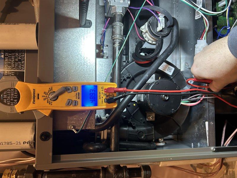 Performed comprehensive furnace tune-up on system less than one year old. Conducted operational testing including gas pressure verification, corrected backwards air filter installation, inspected humidifier and air exchanger, and cleaned routine components. Electrical testing with Fieldpiece meter confirmed proper amperage readings (0.23) across components, and condensate drain was flushed to ensure proper drainage. All systems functioning within normal parameters.