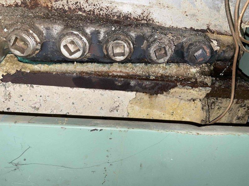 Inspected boiler system and identified catastrophic failure of heat exchanger and sensor well. Water added to boiler immediately leaked through compromised heat exchanger. Informed homeowner that the unit is unrepairable due to discontinued parts availability and extensive damage evidenced by severe corrosion on plumbing components and mechanical fasteners. Homeowner will consider options for boiler replacement.