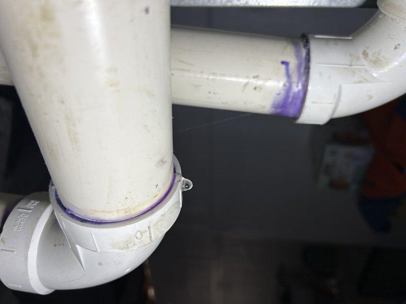 Responded to warranty service call for 2021 furnace installation. Diagnosed PVC condensate line leak occurring at two 90-degree elbow joints. Removed damaged section and replaced with new PVC piping, applying appropriate primer and adhesive at connection points to ensure proper sealing and prevent future leakage.