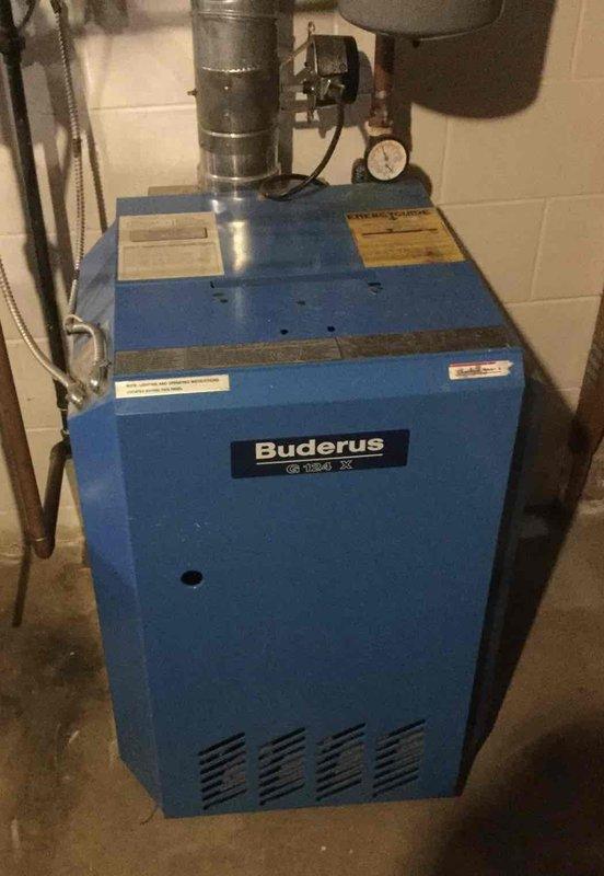 Responded to customer complaint of boiler noise. Inspected Buderus G134 X system and found expansion tank releasing mist when tested and relief valve dripping. Observed normal pressure gauge readings but confirmed popping noises during heating and cooling cycles. Provided customer with quote for radiator removal, boiler flush with Fernox treatment, and expansion tank replacement.