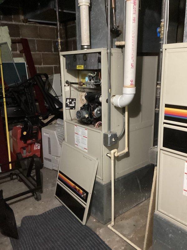 Responded to commercial no-heat call for older furnace making loud noises. Diagnosed broken inducer motor bracket causing motor wobble and preventing proper furnace startup. Inspected heat exchanger, noting significant rust deterioration. Also identified issues with adjacent furnace including plugged condensate drain and broken collector box. Customer approved repairs for both units but is considering replacement of both aging furnaces.