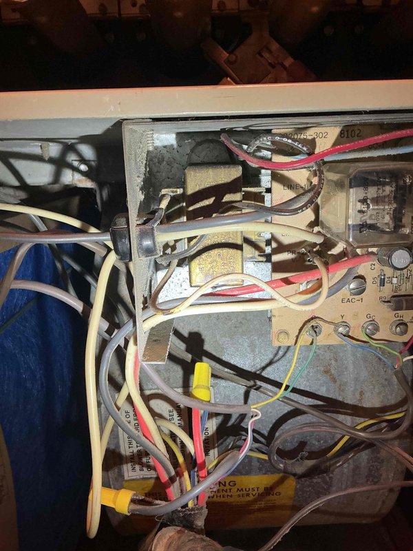 Responded to no heat call for 43-year-old Carrier furnace. Diagnosed broken red thermostat wire disconnected from control board, restored heat by stripping and reconnecting wire. Inspection revealed significant corrosion and scale on heat exchanger, though no visible cracks were found. Advised customer that replacement is recommended due to age and limited parts availability.