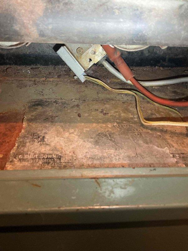 Responded to no heat call for 43-year-old Carrier furnace. Diagnosed broken red thermostat wire disconnected from control board, restored heat by stripping and reconnecting wire. Inspection revealed significant corrosion and scale on heat exchanger, though no visible cracks were found. Advised customer that replacement is recommended due to age and limited parts availability.
