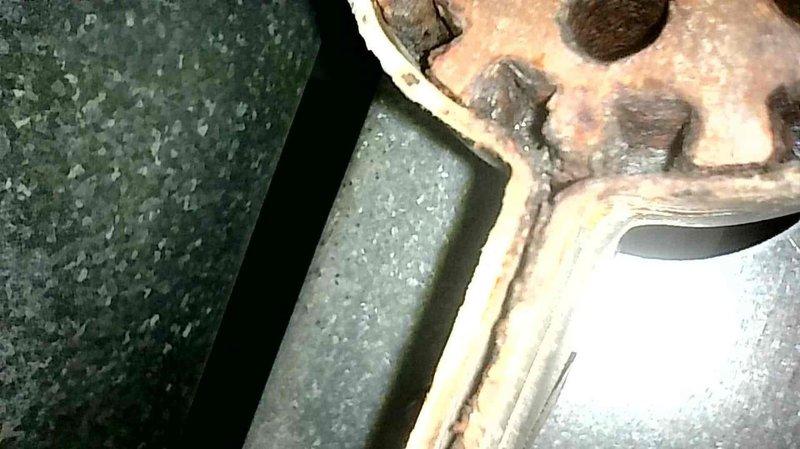 Performed standard furnace tune-up on 20-year-old Trane unit. Inspection revealed critical heat exchanger damage including a ~1" crack beneath the burner and a small crack in the secondary heat exchanger. Documented deterioration with photos showing significant metal corrosion and compromised seals. Advised customer that burner assembly requires replacement and recommended full system replacement due to age and condition. Customer will obtain multiple quotes before deciding on replacement.